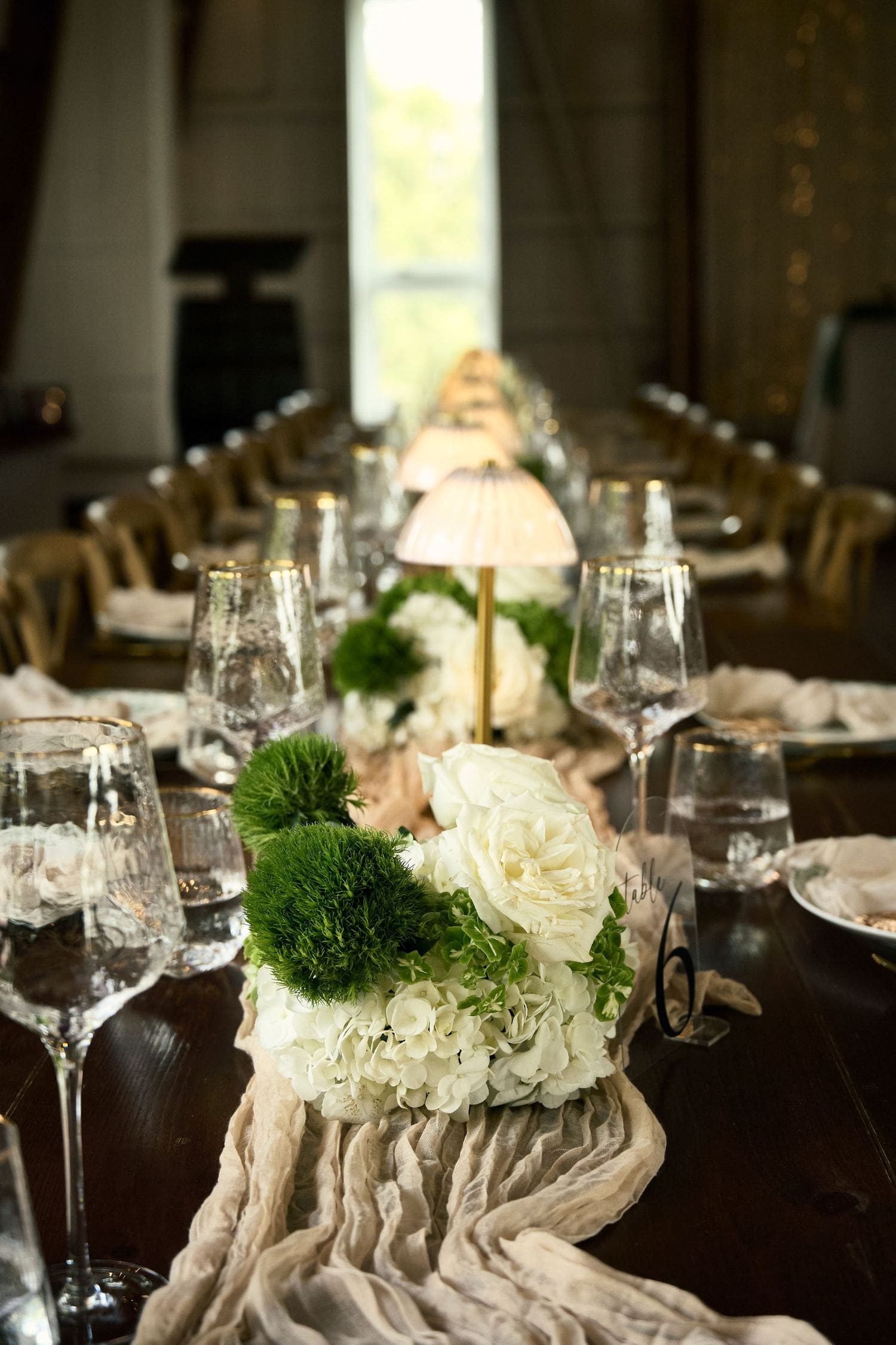 Elegant wedding reception table with white roses and crystal glasses at a Crescent Hill Acres spring wedding