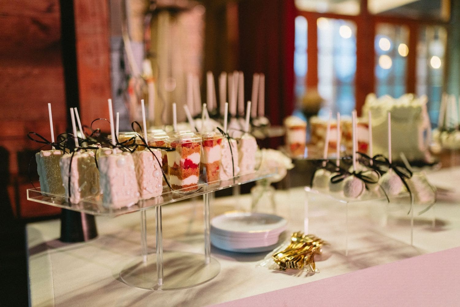 Dessert table with pink cake slices and cake pops at a Sebastopol wedding reception